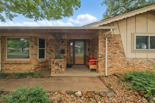 4816 Reynolds Rd, North Richland Hills, TX 76180 - doorway to property with board and batten siding and brick siding
