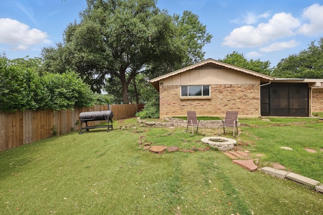 4816 Reynolds Rd, North Richland Hills, TX 76180 - view of yard featuring an outdoor fire pit and a sunroom