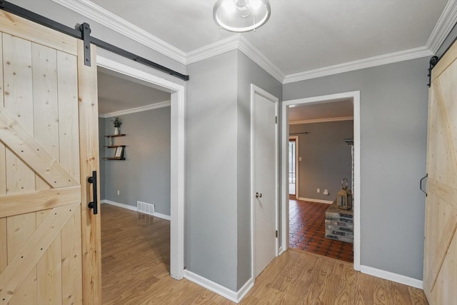 4816 Reynolds Rd, North Richland Hills, TX 76180 - hallway featuring a barn door, light wood-style flooring, crown molding, and baseboards