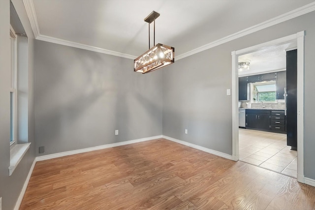 4816 Reynolds Rd, North Richland Hills, TX 76180 - unfurnished room featuring crown molding, light wood-style floors, baseboards, and a sink
