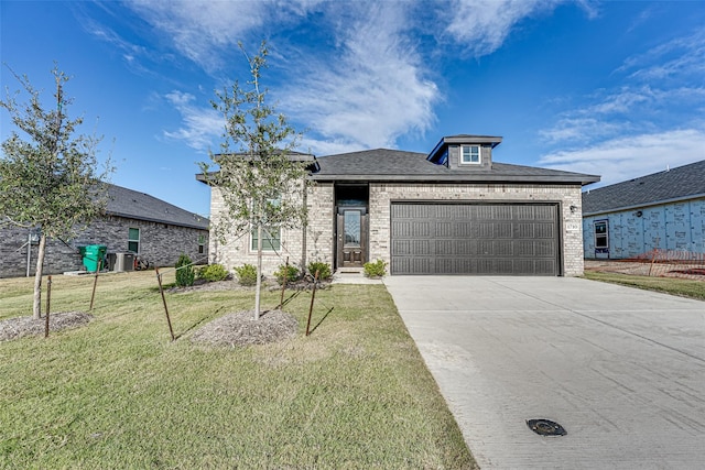 1710 Citrus Dr, Sherman, TX 75092 - view of front of house with a front lawn, brick siding, driveway, and an attached garage