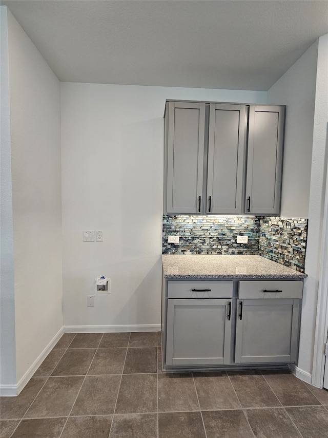 1710 Citrus Dr, Sherman, TX 75092 - washroom featuring baseboards and dark tile patterned flooring