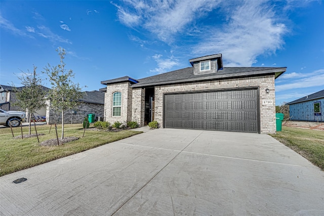 1710 Citrus Dr, Sherman, TX 75092 - view of front of home featuring concrete driveway, brick siding, a front yard, and a garage