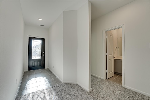 1710 Citrus Dr, Sherman, TX 75092 - doorway to outside with light tile patterned floors, baseboards, light colored carpet, and recessed lighting