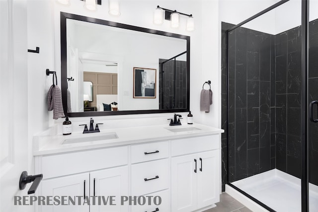 full bath with a stall shower and double vanity