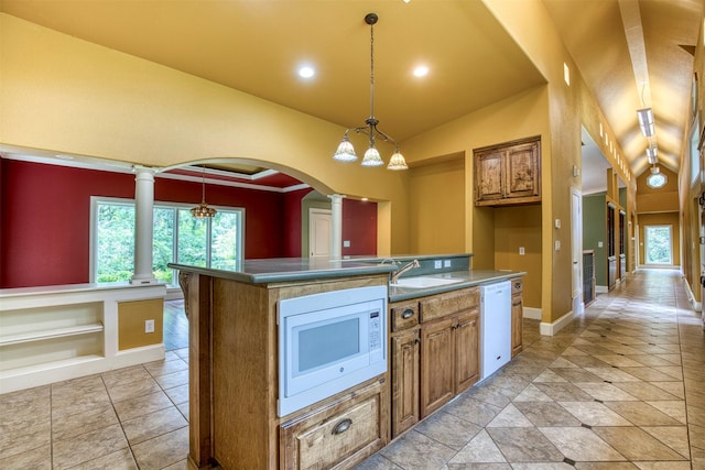 711 Pearl Cv, Oak Point, TX 75068 - kitchen with white appliances, ornate columns, brown cabinets, vaulted ceiling, and recessed lighting