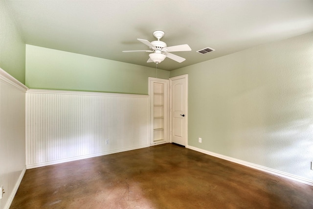 711 Pearl Cv, Oak Point, TX 75068 - empty room with concrete flooring, ceiling fan, baseboards, and wainscoting