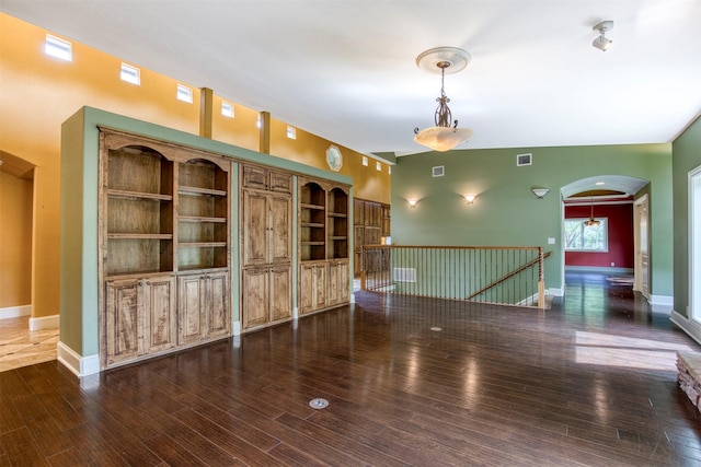 711 Pearl Cv, Oak Point, TX 75068 - spare room featuring arched walkways, wood finished floors, and baseboards