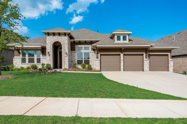 7804 Caddo Cv, Mckinney, TX 75071 - view of front of home with a garage, driveway, a front lawn, stone siding, and stucco siding
