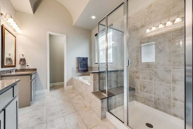 7804 Caddo Cv, Mckinney, TX 75071 - bathroom with vanity, a garden tub, a stall shower, baseboards, and marble finish floors
