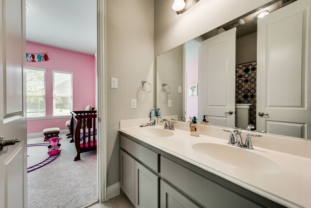 7804 Caddo Cv, Mckinney, TX 75071 - full bathroom with double vanity and baseboards