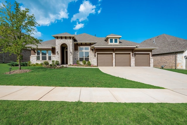 7804 Caddo Cv, Mckinney, TX 75071 - prairie-style house featuring a garage, a front yard, concrete driveway, and stone siding