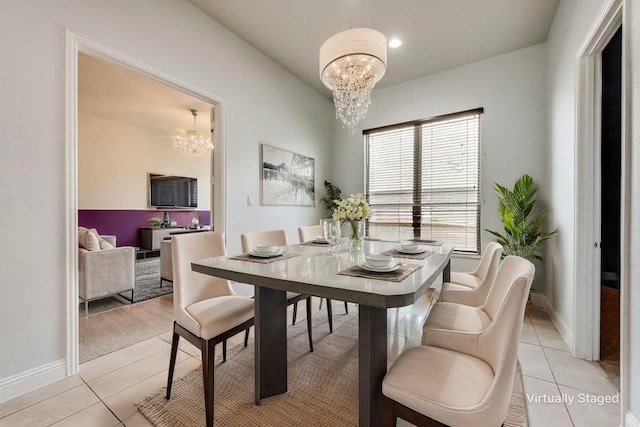 7804 Caddo Cv, Mckinney, TX 75071 - dining area featuring a chandelier, light tile patterned floors, and baseboards