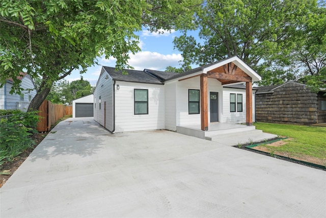 1608 Carolyn St, Irving, TX 75061 - view of front of home featuring an outbuilding, fence, a detached garage, and a porch