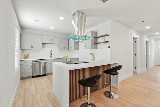 1608 Carolyn St, Irving, TX 75061 - kitchen featuring stainless steel dishwasher, island exhaust hood, gray cabinets, a peninsula, and a sink