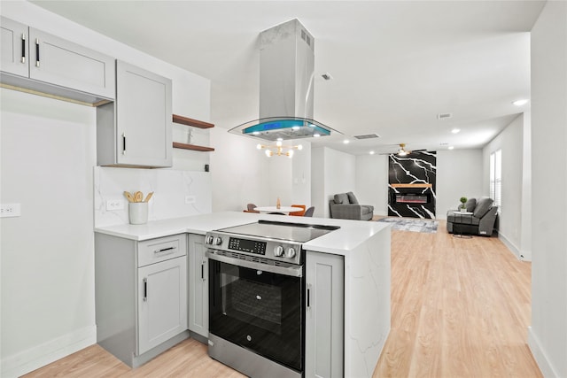 1608 Carolyn St, Irving, TX 75061 - kitchen with electric range, island range hood, a peninsula, light wood-type flooring, and open shelves