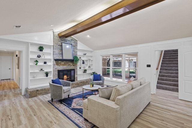 2809 Valley Ridge Dr, Richardson, TX 75080 - living area with a brick fireplace, light wood finished floors, stairs, and built in features