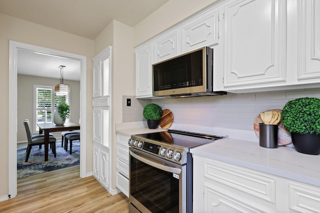 2809 Valley Ridge Dr, Richardson, TX 75080 - kitchen featuring stainless steel appliances, white cabinetry, light wood-type flooring, backsplash, and light stone countertops