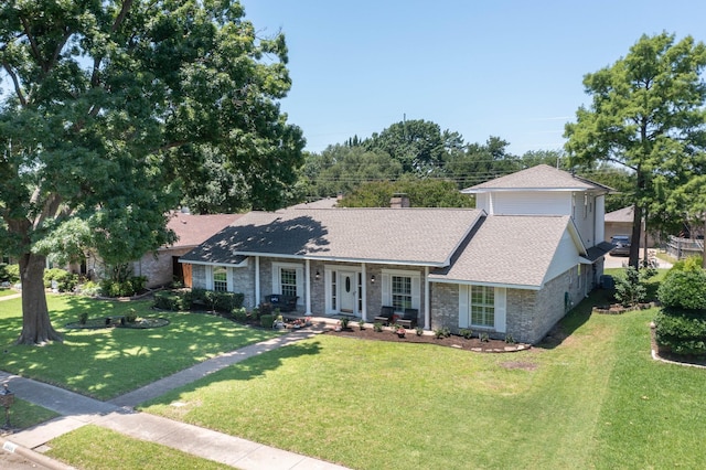 2809 Valley Ridge Dr, Richardson, TX 75080 - view of front facade with a front yard, roof with shingles, stone siding, and a chimney