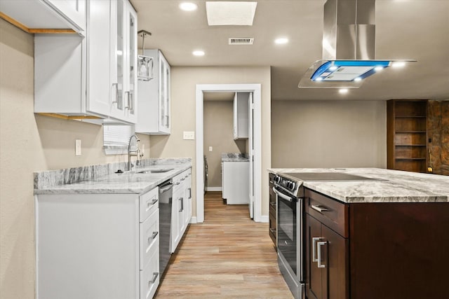 612 S Mills Dr, Euless, TX 76040 - kitchen featuring appliances with stainless steel finishes, a sink, light wood-style flooring, dark brown cabinets, and white cabinets