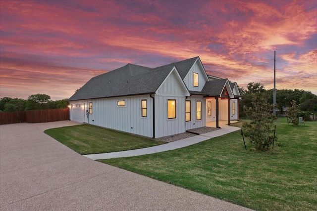 207 Merrifield Dr, Woodway, TX 76712 - back of property at dusk featuring board and batten siding, concrete driveway, a shingled roof, and an attached garage
