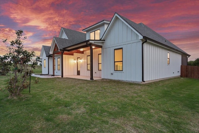 207 Merrifield Dr, Woodway, TX 76712 - back of property at dusk featuring board and batten siding, roof with shingles, and a patio area