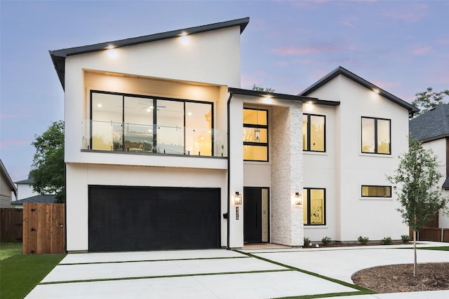 4326 Merrell Rd, Dallas, TX 75229 - modern home with stucco siding, fence, driveway, and a garage
