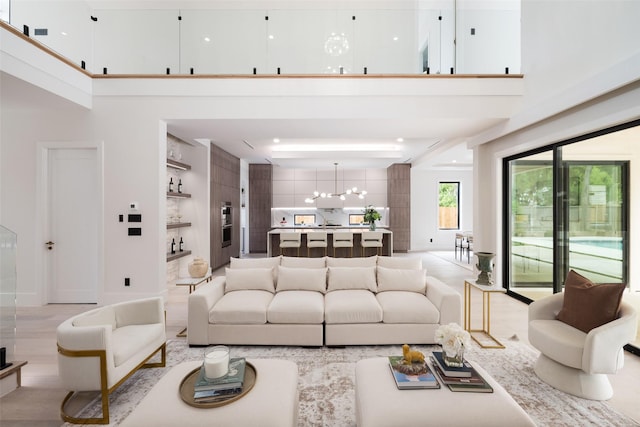 4326 Merrell Rd, Dallas, TX 75229 - living area with a chandelier, a high ceiling, and built in shelves