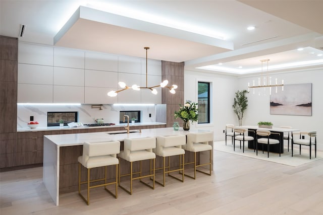 4326 Merrell Rd, Dallas, TX 75229 - kitchen featuring modern cabinets, a chandelier, a kitchen bar, light countertops, and recessed lighting