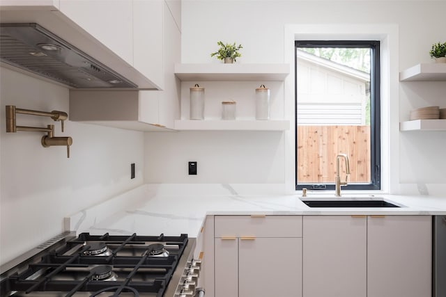4326 Merrell Rd, Dallas, TX 75229 - kitchen with open shelves, under cabinet range hood, a sink, and white cabinetry