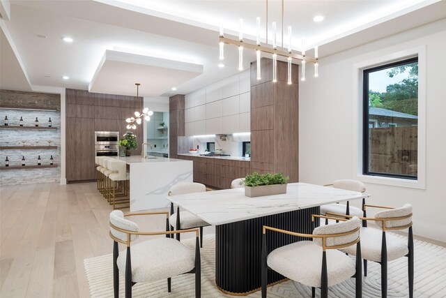 4326 Merrell Rd, Dallas, TX 75229 - dining room with light wood-type flooring, recessed lighting, and a chandelier