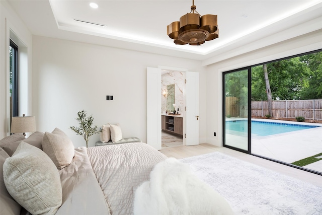 4326 Merrell Rd, Dallas, TX 75229 - bedroom with access to outside, a tray ceiling, a chandelier, ensuite bath, and light wood-type flooring