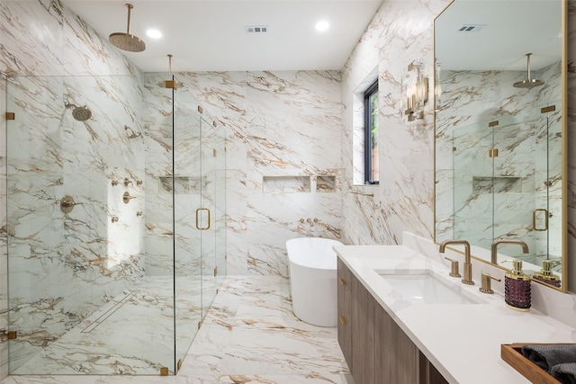 4326 Merrell Rd, Dallas, TX 75229 - bathroom with a marble finish shower, tile walls, a freestanding bath, stone wall, and vanity