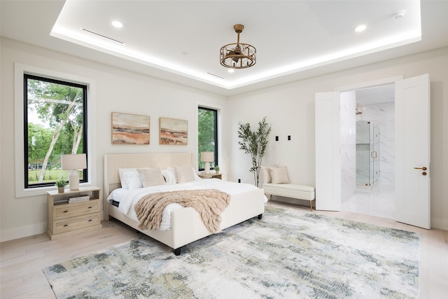 4326 Merrell Rd, Dallas, TX 75229 - bedroom with a raised ceiling, light wood-style flooring, recessed lighting, ensuite bathroom, and baseboards