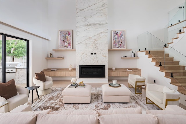 4326 Merrell Rd, Dallas, TX 75229 - living area featuring a high ceiling, wood finished floors, stairway, and a high end fireplace