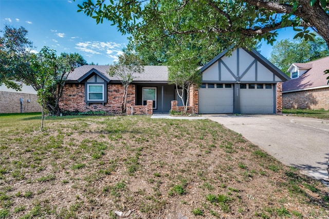 4228 Longleaf Ln, Fort Worth, TX 76137 - tudor house with an attached garage, concrete driveway, brick siding, and a front yard