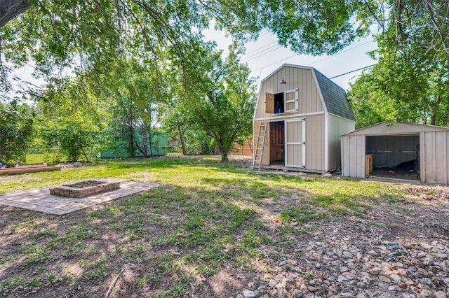 4228 Longleaf Ln, Fort Worth, TX 76137 - view of grassy yard featuring a shed, an outdoor fire pit, and an outbuilding