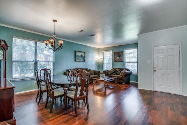 3815 Pinebluff Ln, Rockwall, TX 75032 - dining area with dark wood finished floors, crown molding, a chandelier, and baseboards