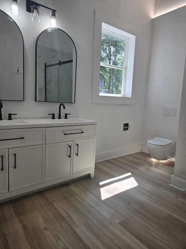 109 Anderson Ln, Mabank, TX 75156 - full bath featuring a marble finish shower, double vanity, toilet, wood finished floors, and baseboards