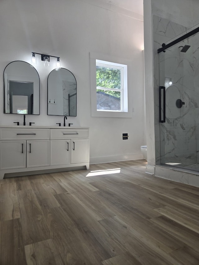 109 Anderson Ln, Mabank, TX 75156 - bathroom with wood finished floors, a marble finish shower, toilet, double vanity, and baseboards