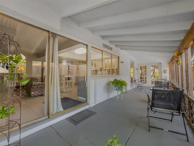 sunroom featuring french doors and beam ceiling