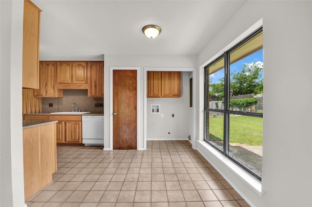 1208 Kay Dr, Weatherford, TX 76086 - kitchen featuring dishwasher, a sink, backsplash, light countertops, and light tile patterned floors
