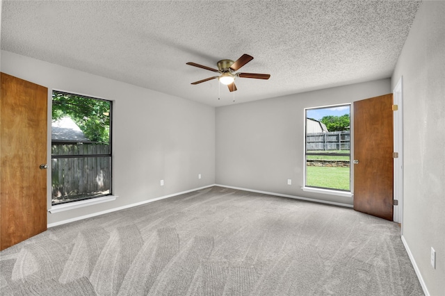 1208 Kay Dr, Weatherford, TX 76086 - carpeted spare room with plenty of natural light, a ceiling fan, a textured ceiling, and baseboards