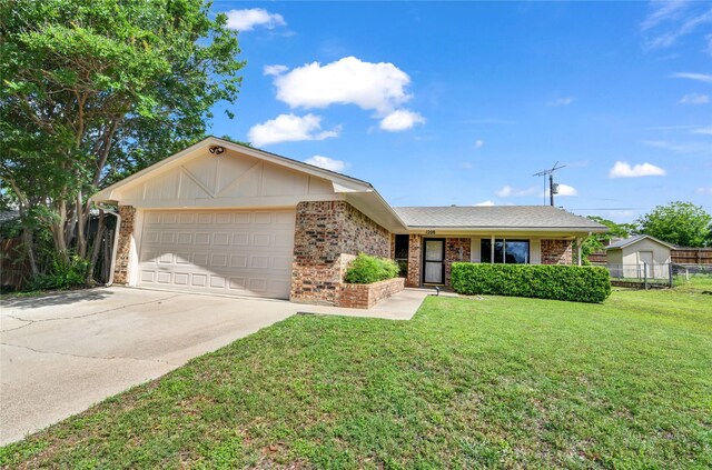 1208 Kay Dr, Weatherford, TX 76086 - ranch-style house featuring an attached garage, driveway, and brick siding