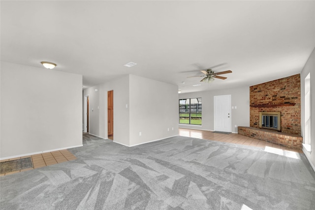 1208 Kay Dr, Weatherford, TX 76086 - unfurnished living room featuring ceiling fan, carpet floors, a brick fireplace, tile patterned floors, and baseboards