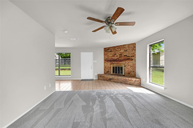 1208 Kay Dr, Weatherford, TX 76086 - unfurnished living room with carpet, ceiling fan, a fireplace, and baseboards