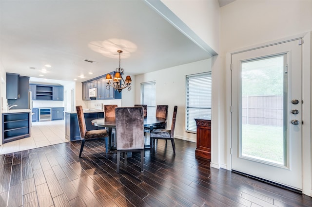 1600 Railhead Pl, Carrollton, TX 75007 - dining room featuring a chandelier, dark wood-style floors, and plenty of natural light