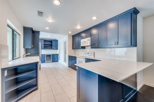 1600 Railhead Pl, Carrollton, TX 75007 - kitchen with open shelves, white appliances, wine cooler, a peninsula, and blue cabinets