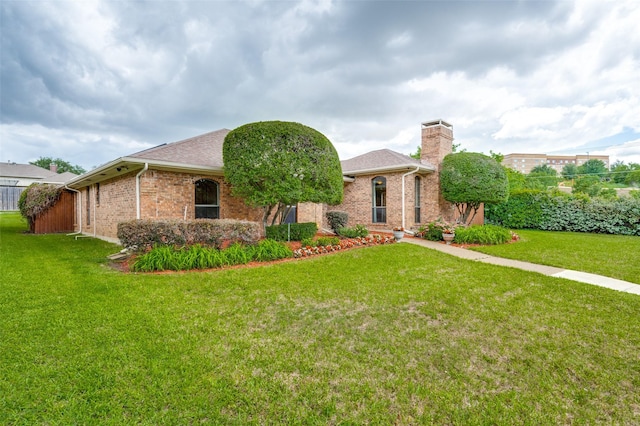 1600 Railhead Pl, Carrollton, TX 75007 - view of front of home featuring a chimney, a front lawn, brick siding, and roof with shingles