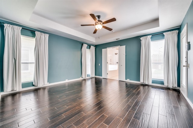 1600 Railhead Pl, Carrollton, TX 75007 - unfurnished room with a raised ceiling, a ceiling fan, healthy amount of natural light, and wood finished floors